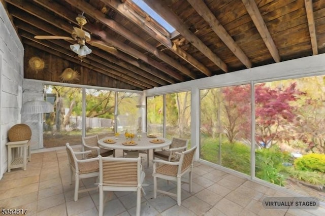 sunroom / solarium featuring outdoor dining space and beam ceiling