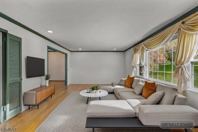 living room with crown molding, light wood-style floors, and recessed lighting