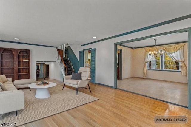 living room with stairs, wood finished floors, and a chandelier