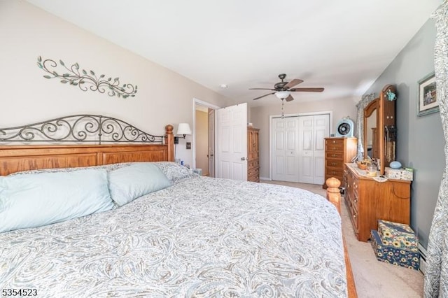 bedroom featuring a closet, ceiling fan, and light carpet