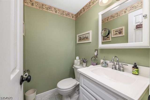 bathroom featuring toilet, tile patterned floors, and vanity