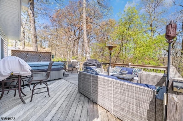 deck with an outdoor living space and area for grilling