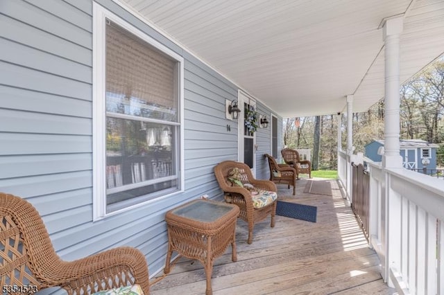 wooden terrace featuring covered porch