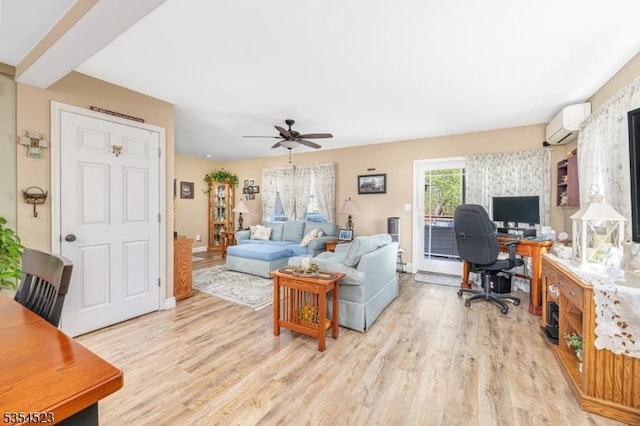 living area featuring ceiling fan, a wall mounted AC, baseboards, and light wood-style floors