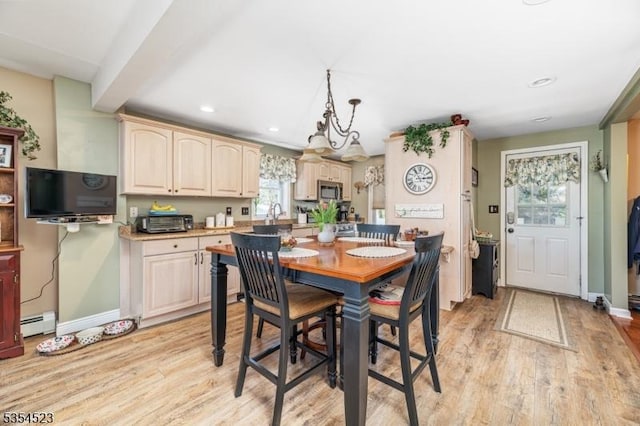 dining area featuring recessed lighting, baseboards, a baseboard heating unit, and light wood-style flooring