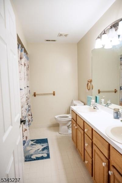 full bathroom featuring a sink, toilet, and visible vents