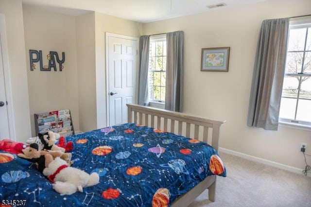 carpeted bedroom with baseboards, visible vents, and multiple windows