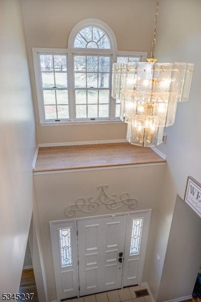 foyer with a high ceiling and a healthy amount of sunlight