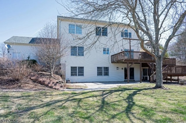 rear view of property featuring stairs, a yard, a deck, and a patio