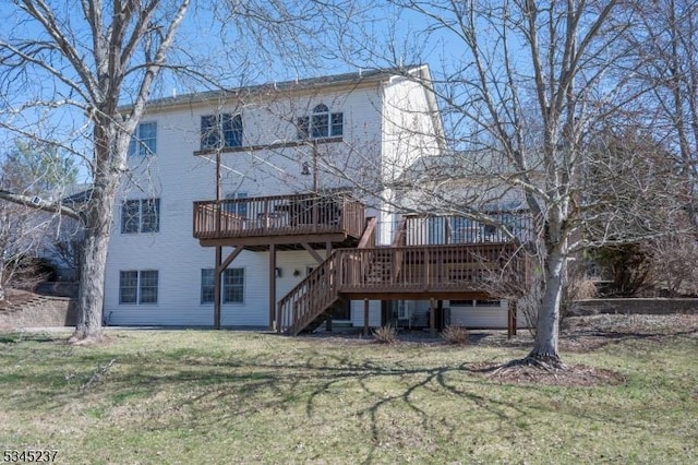 back of property featuring a yard, a deck, and stairway