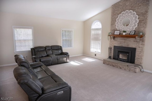 carpeted living area featuring baseboards, lofted ceiling, and a fireplace