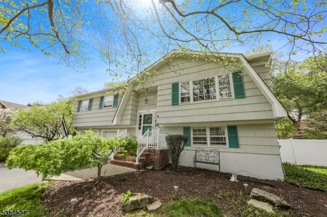 bi-level home featuring fence