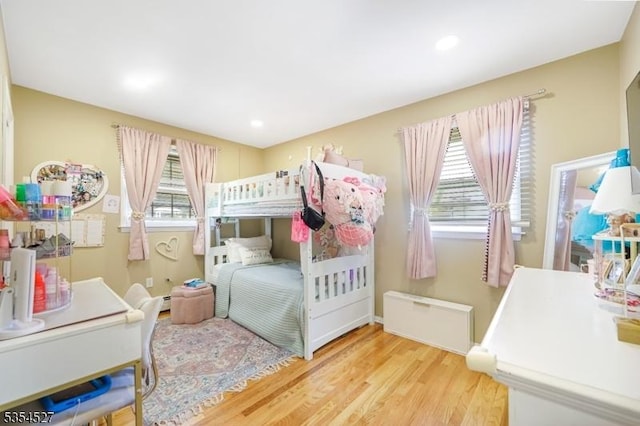 bedroom with baseboards, recessed lighting, and wood finished floors