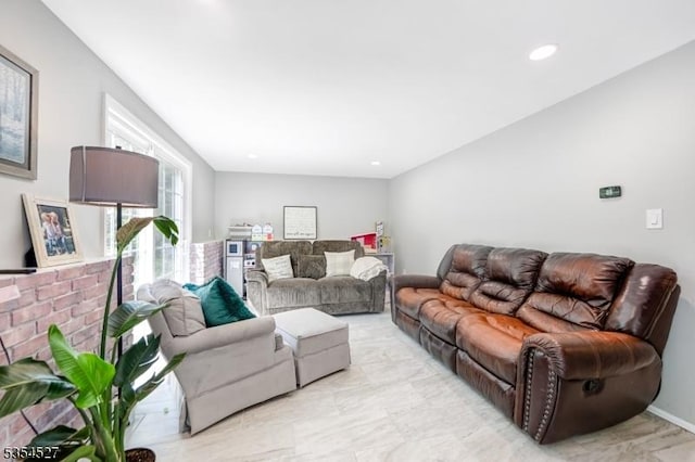 living area featuring recessed lighting and marble finish floor