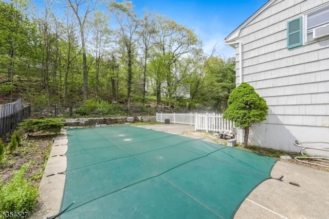 view of swimming pool featuring a fenced in pool and fence