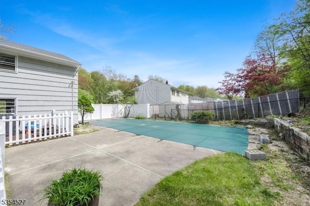 view of pool featuring a fenced in pool, a fenced backyard, and a patio area