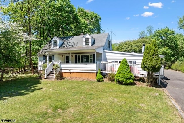 226 Wilson Rd, Franklin Twp, NJ 08873 - cape cod home featuring aphalt driveway, covered porch, and a front yard