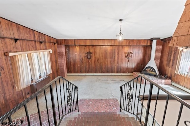 226 Wilson Rd, Franklin Twp, NJ 08873 - staircase with a wood stove, wooden walls, and a healthy amount of sunlight