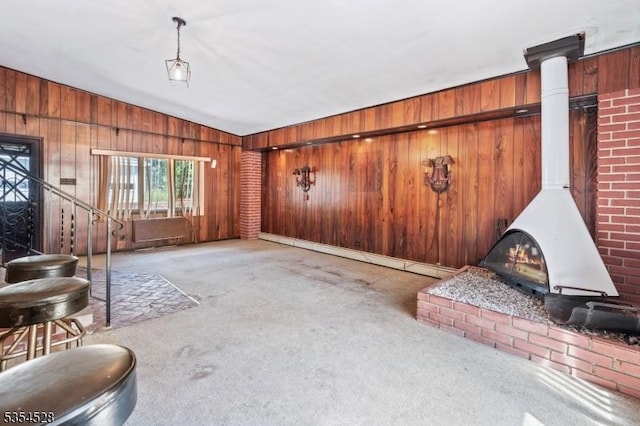 226 Wilson Rd, Franklin Twp, NJ 08873 - carpeted living room featuring vaulted ceiling, wood walls, and a wood stove