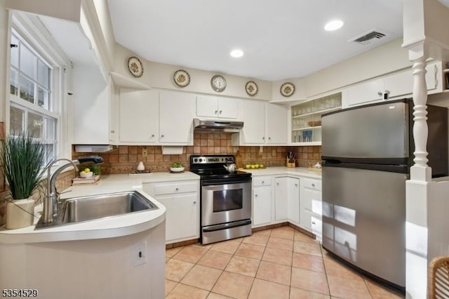 kitchen with visible vents, a sink, light countertops, under cabinet range hood, and stainless steel appliances