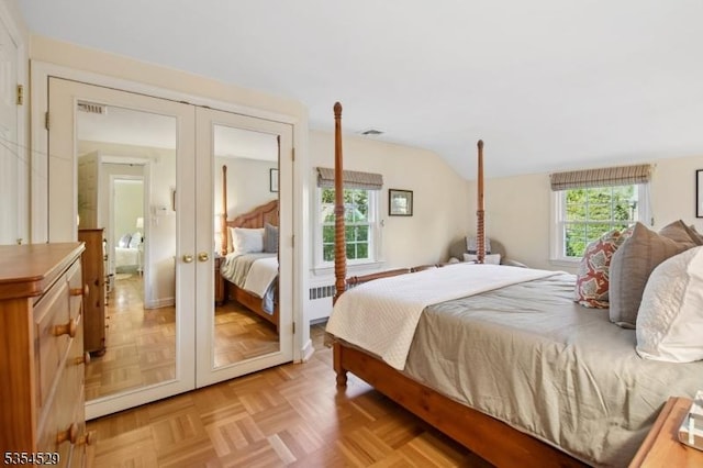 bedroom with radiator, visible vents, french doors, and lofted ceiling