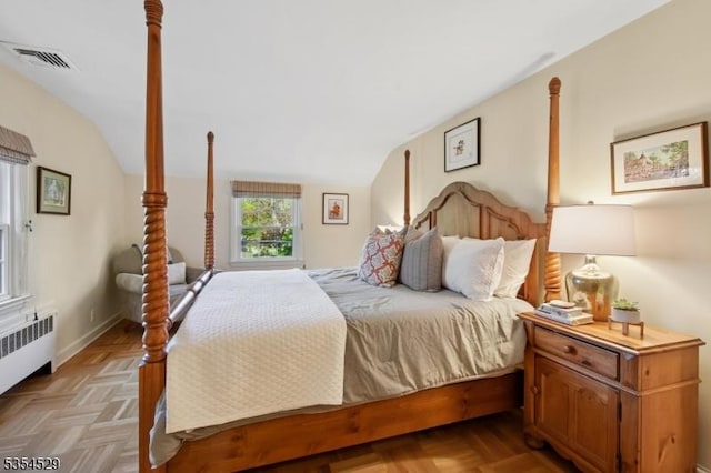 bedroom with visible vents, lofted ceiling, and radiator heating unit