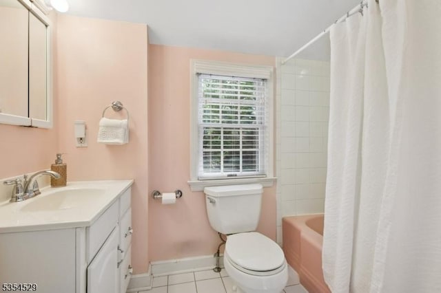 bathroom featuring shower / bath combination with curtain, tile patterned floors, baseboards, vanity, and toilet