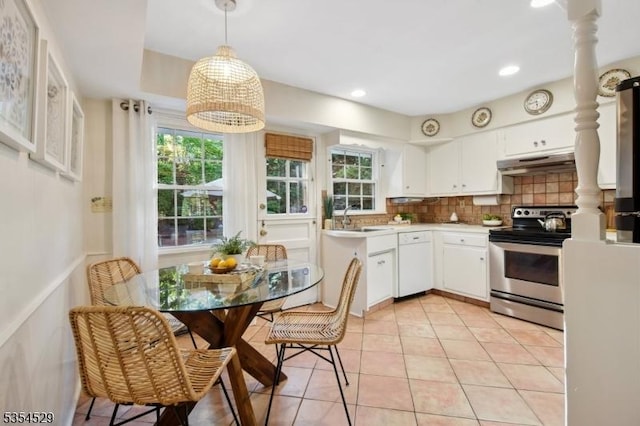 kitchen with white dishwasher, stainless steel electric range oven, a sink, under cabinet range hood, and white cabinetry