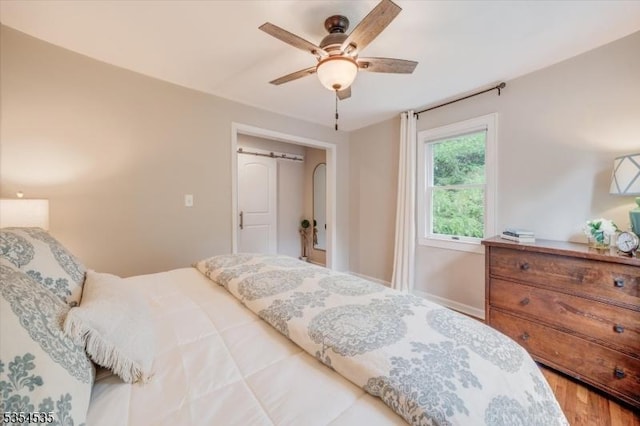 bedroom featuring wood finished floors and ceiling fan