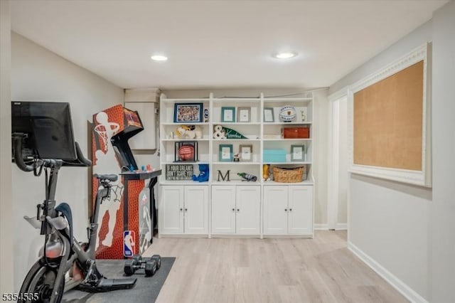 exercise room with light wood-type flooring, baseboards, and recessed lighting