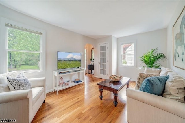 living area with light wood finished floors and baseboards