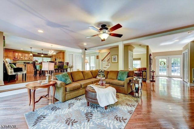 living area with a ceiling fan, recessed lighting, stairway, and light wood-type flooring