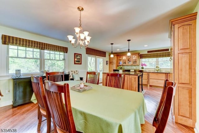 dining room with an inviting chandelier, recessed lighting, light wood-style floors, and a healthy amount of sunlight