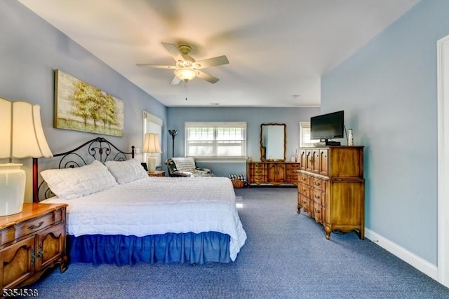 carpeted bedroom featuring baseboards and ceiling fan