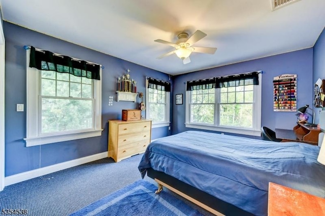 bedroom featuring a ceiling fan, baseboards, visible vents, and carpet