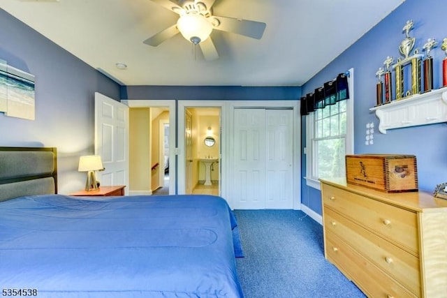 carpeted bedroom with connected bathroom, baseboards, ceiling fan, and a closet
