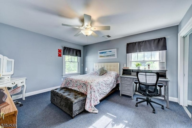 carpeted bedroom featuring baseboards, visible vents, and multiple windows
