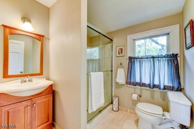full bathroom featuring vanity, a shower stall, tile patterned floors, and toilet