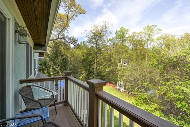 balcony featuring a view of trees