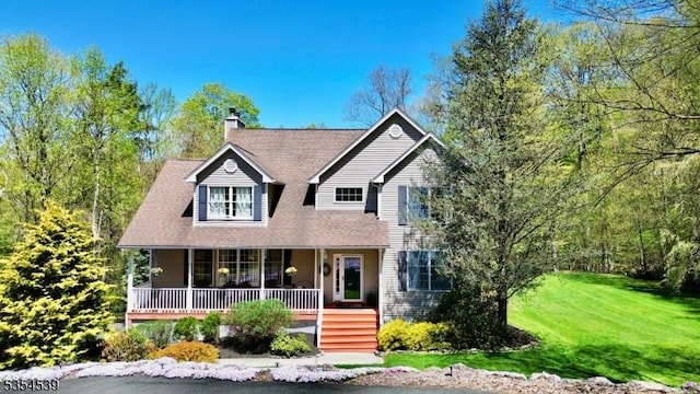view of front of house with a porch, a chimney, and a front yard
