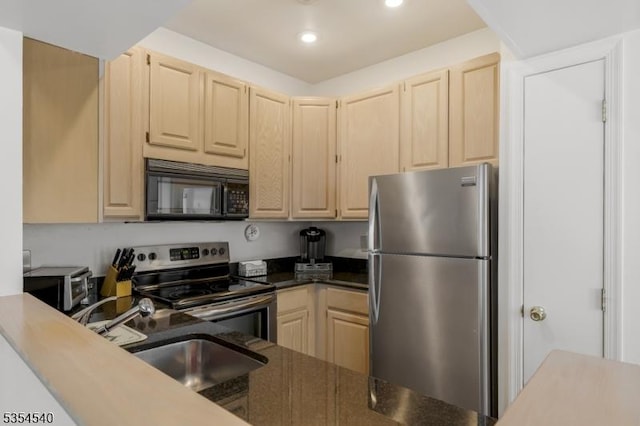 kitchen with appliances with stainless steel finishes, light brown cabinets, a sink, and recessed lighting