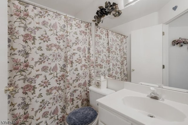 full bathroom with a sink, toilet, and a shower with shower curtain