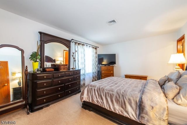 bedroom with visible vents and light colored carpet