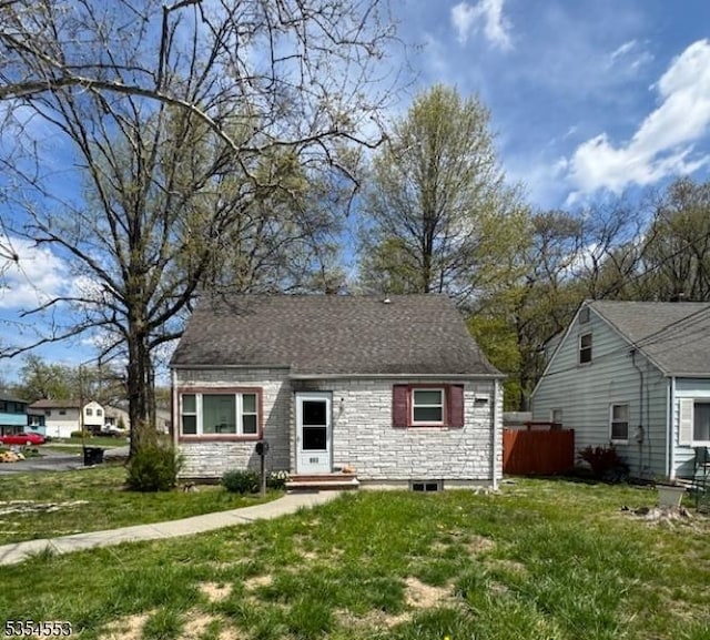 view of front of home with a front lawn and fence