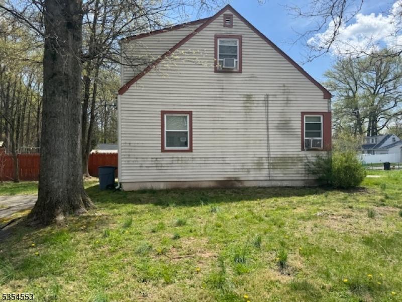 view of property exterior featuring fence, a yard, and cooling unit