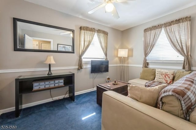 living room featuring baseboards, carpet, and a ceiling fan