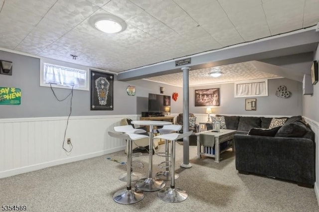 interior space featuring carpet and a wainscoted wall