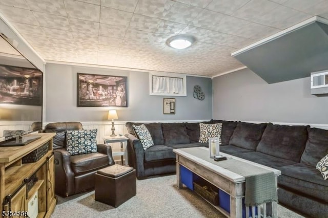 carpeted living area with wainscoting and ornamental molding