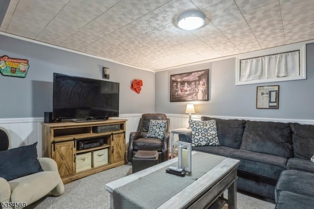 carpeted living room featuring wainscoting