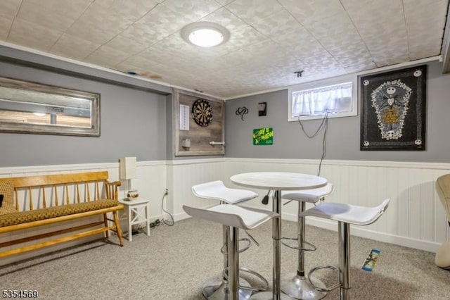 interior space featuring carpet flooring and wainscoting